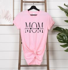 Mom Shirt, Kids Names Shirt, Personalized Mom Shirt, Custom Mom Shirt, Mothers Day Shirt, Mom Birthday Gift, Gift for Mom, Mama Shirt HOW TO PLACE YOUR ORDER * Choose your t-shirt color * Choose your size * Choose your design&text color * PLEASE make sure all your order's steps PRODUCT DESCRIPTION T-shirt feels soft and light, with just the right amount of stretch. It's comfortable and the unisex cut is flattering for both men and women. * Solid colors are 100% combed and ring-spun cotton * Ash color is 99% combed and ring-spun cotton, 1% polyester * Heather colors are 52% combed and ring-spun cotton, 48% polyester * Athletic and Black Heather are 90% combed and ring-spun cotton, 10% polyester * Heather Prism colors are 99% combed and ring-spun cotton, 1% polyester * Fabric weight: 4.2 oz/ Design Text, Kids Names, Mothers Day Shirts, Prism Color, Mom Birthday, Mama Shirt, Ash Color, Mom Birthday Gift, Mom Shirt