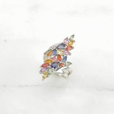 This ring is a size 7 (USA); It may be resized. Markings: 925, DK (Tested & guaranteed to be Sterling Silver) This ring weighs 6.8 Grams The Stone/Design is Multi Color Rainbow Sapphire, Tanzanite Cocktail - Natural, BE Treated sapphires  The Stone/Design measures 5.2 x 4.1 mm The Ring face measures 36 x 17.9 mm The condition of this ring is Estate, Great, light patina This vintage item is circa pre 2004  To have us do the resize, add this listing and the resize listing to your cart and select w Fine Jewelry Marquise Multi-stone Ring, Marquise Multi-stone Cubic Zirconia Rings, Marquise Cubic Zirconia Multi-stone Rings, Multicolor Cluster Fine Jewelry, White Gold Multi-stone Cluster Ring Gift, Multicolor Cluster Rings With Accent Stones, Silver Marquise Multi-stone Diamond Ring, Sterling Silver Marquise Cluster Ring For Anniversary, Multicolor Hallmarked Fine Jewelry Rings