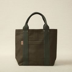 Heavy weight canvas medium tote in khaki green 16.5" x 5.5" x 12.6" Made in Japan Threadline is a Japanese-manufactured line of heavy canvas bags designed for everyday use. Khaki Canvas Bag For On-the-go, Green Canvas Bag With Leather Handles For On-the-go, Khaki Tote Canvas Bag For Everyday Use, Everyday Khaki Canvas Tote Bag, Khaki Canvas Tote Bag For Everyday, Khaki Canvas Bag With Top Carry Handle, Practical Canvas Bag With Leather Handles, Khaki Canvas Bag For Daily Use, Khaki Canvas Tote Bag With Canvas Lining