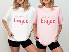 two women standing next to each other wearing matching shirts that say bride and bouyee