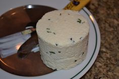 a white cake sitting on top of a plate