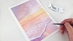 a person is painting an ocean scene with pastel pencils and watercolor paper