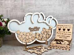 there is a wooden cutout of a cloud with flowers in the background and other items to make it stand out