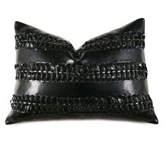 a black leather pillow with braiding on the front and back side, sitting on a white background