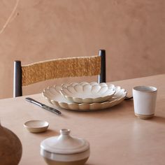 a table with plates, cups and spoons on it