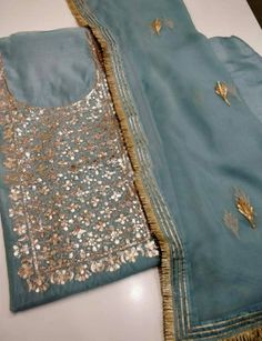 Item Overview ATHARVA Hand Embroidered Salwar Kameez w/Embroidery Neck Blue Grey w/Gota Patti Dupatta/Custom Stitch/Tunic/Pants/Patiala Salwar/ Dno. CH1485 Fabric: * Shirt Chanderi Silk - Embroidered Neck- Blue Grey - 2.5 Mts Beautiful Hand Embroidered Neck. * Dupatta: Chiffon Chinnon Dupatta- 2.5 Mts- Gota Patti work- Blue Grey * Bottom Santoon Silk 2.5 Mts. Excusive Hand Embroidered Party Wear Punjabi Suit. Customization: * Fabrics Customization: Designs Can be made in different Fabrics. *Colo Indian Outfits Modern, Patiala Salwar Kameez, Cotton Salwar Kameez, Neck Embroidery, Patiala Salwar, Embroidered Pants, Chiffon Dupatta, Shirt Embroidery, Punjabi Suits