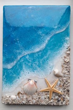 an ocean scene with shells and starfish on the beach