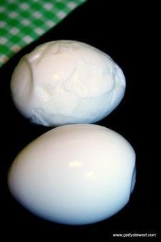 two white eggs sitting on top of a table