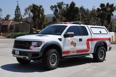 a white police truck parked in a parking lot