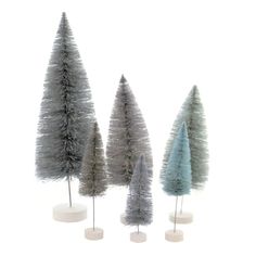 three small trees in different colors and sizes