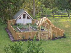 an aerial view of a small garden with a shed in the middle and trees surrounding it