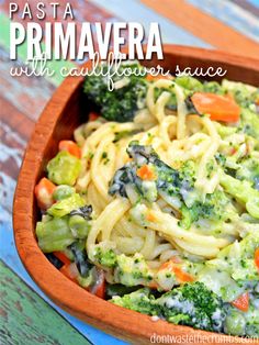 pasta with broccoli and carrots in a wooden bowl