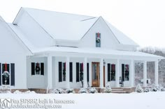 a white house covered in snow with wreaths on the front door and porch windows