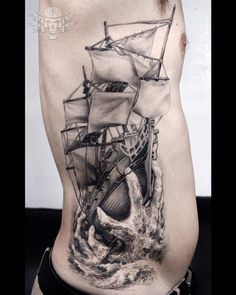 a man's back with a ship on it and waves coming up from the water