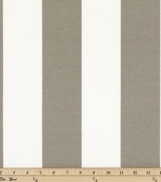 a ruler is next to a gray and white striped fabric