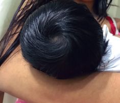 a close up of a person with long hair on their head and one arm wrapped around another woman's shoulder