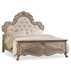 an antique style bed with tufted headboard and foot board, made from wood