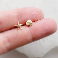 "⚡️ FREE SHIPPING ⚡️ on Domestic orders over $35 🇺🇸 🐚 Ready to bring a touch of the beach to your jewelry collection? Order our Seashell Stud Set today and let your style sparkle with a tropical twist. Whether you're heading to the beach or just want to channel those relaxed vacation vibes, these studs are the perfect accessory. NOTE WHEN ORDERING: Singles = 3 earrings (1 of each). Pair = 6 earrings (2 of each) * T H E * D E T A I L S *  * All components are Sterling silver or 14K Gold Fill * 3 Earrings, Matching Pairs, Starburst Earrings, Multiple Piercings, Seashell Earrings, Starfish Earrings, White Jewelry Box, Sunny California, Tiny Earrings