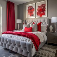 a bed with red and white pillows on top of it next to two pictures above the bed