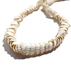 These classic beach garlands feature White Cockles shells expertly drilled and strung on clear thread. Perfect for adding a touch of coastal charm to your home decor. You can also snip the shells from the thread and use them to craft coastal-themed jewelry, decorations, or embellish bags and hats. Each shell is about 1-2cm in size with a 1mm hole. Sourced: The Gambia White Shell Strand, White Strand Shell Necklace Ocean-inspired, White Shell Necklace, Ocean-inspired, Ocean-inspired White Shell Strand Necklace, White Ocean-inspired Shell Strand Necklace, Ocean-inspired Shell Necklace, White Ocean-inspired Strand Shell Necklace, White Ocean-inspired Shell Necklace, White Coastal Style Shell-shaped Shell