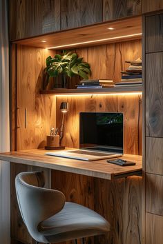 a wooden desk topped with a laptop computer next to a plant and lamp on top of it