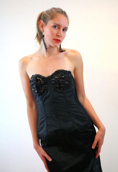 "This is an extraordinary and rare 1940s vintage undergarment, unearthed in an old Vermont house clean-out! It's essentially a 40s body shaping corset, a long line bustier bra, a skirt slip and a garter belt - all in one!! The upper portion is crisp black satin acetate in the front and on the sides, with a black and gold lace strapless bustier bra with underwires. Nine bars of flexible boning extend down inside from the bra. The upper sides and back edges are elasticized, and in the back two 2-i Gold Bustier, Body Shaping Corset, Back Edges, Vermont House, Strapless Bustier, Lace Strapless, Garter Belts, Lace Corset, Gold Lace