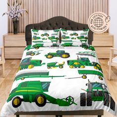 a bed with green tractors on it in a room