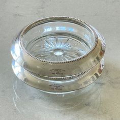 an empty glass dish sitting on top of a table