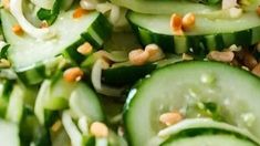 cucumbers and onions are mixed together to make a salad with sesame seeds on top