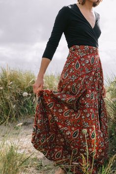 Hand block printed, creating sustainable livelihoods for female artisans. The Maxi Wrap Skirt in Paisley Maroon is seasonless by design. Made from soft, light cotton the wrap skirt is incredibly comfortable, offering style with flattering movement from the waist. Gathers and ties at the side or back of the waist. Crafted with three waist loopholes for an adjustable, flexible fit. Upper ankle Length. Model is 5'8 tall, size UK 10, US 6 and is wearing the S/M. Printed onto 100% cotton. Plant-based Semi Formal Dress Code, Maxi Wrap Skirt, Wrap Maxi Skirt, Fall Capsule Wardrobe, Printed Maxi, Soft Light, Festival Outfits, Wrap Skirt, Skirt Outfits