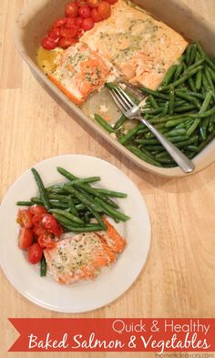 baked salmon and vegetables in a casserole dish with a fork on the side