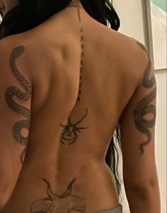 the back of a woman with tattoos on her body