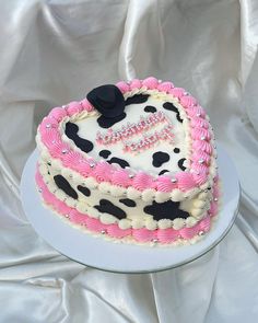 a cake with pink and white frosting on it