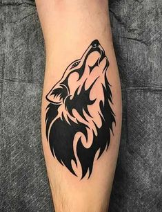 a black and white wolf tattoo on the leg