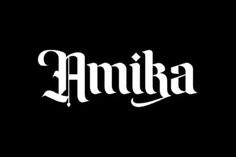 the word amika written in white ink on a black background with an ornate font