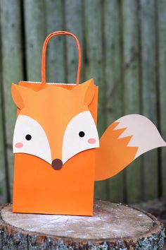 an orange paper bag with a fox face on it