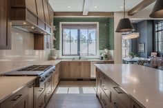 a kitchen with wooden cabinets and white counter tops, along with an island in the middle