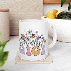 a coffee mug with the word gig surrounded by flowers