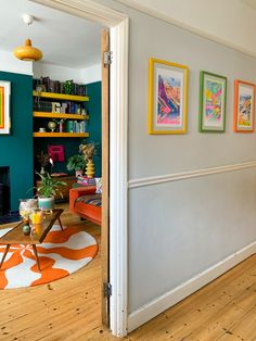 a living room filled with furniture and pictures on the wall