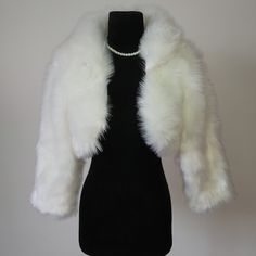 Material: Faux fur Color: Ivory Size:  One size fits all It is made of high-quality artificial fur.the coat is very beautiful, comfortable to wear, and the long fluff is extremely warm. Shipping time: 20 working days We accept returns. Washing not supported. Cropped Fur Jacket, Fur Clothes, White Fur Jacket, Fur Outfit, White Faux Fur Coat, Winter Mode Outfits, Tops Winter, White Fur Coat