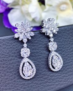 HANDCRAFTED TO PERFECTION! SPECIAL AND LOVELY FLORAL DESIGN, ILLUSION SETTING (APPEARS TO BE LIKE A 0.5 CARAT BRILLIANT PEAR Diamonds). With over 128 pieces of UNTREATED AND GENUINE F/VS QUALITY SPARKLING DIAMONDS! Perfect for every event! SET IN 18K SOLID WHITE GOLD HANDCRAFTED, DANGLING EARRINGS! SUGGESTED RETAIL VALUE: $8,800 DIAMONDS: 128 ROUND BRILLIANT, FULL CUT with excellent firing diamonds, weighting at 2.16 carats. ALL NATURAL, UNTREATED DIAMONDS. ALL DIAMONDS HAVE NO VISIBLE INCLUSION Luxury Pear-shaped Bridal Earrings For Wedding, Luxury Teardrop Diamond Earrings For Wedding, Elegant Brilliant Cut Chandelier Earrings For Gifts, Pear-shaped Diamond Chandelier Earrings For Wedding, Dazzling White Gold Bridal Earrings In Pear Shape, Teardrop Brilliant Cut Chandelier Earrings For Wedding, Dazzling White Gold Pear-shaped Bridal Earrings, Wedding Diamond Chandelier Earrings, Teardrop Chandelier Earrings With Brilliant Cut For Wedding