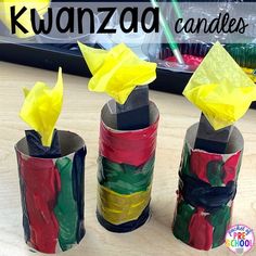 three rolls of toilet paper with yellow tissue paper on them and the words kwanza candles