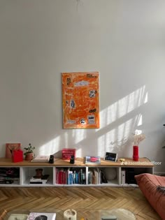 a living room filled with furniture and a large painting hanging on the wall above it