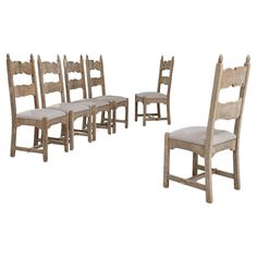 a set of six wooden chairs with upholstered seats