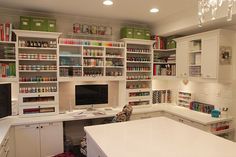 a kitchen with lots of white cabinets and shelves