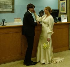 a man and woman standing in front of a counter