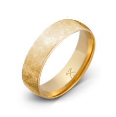 a gold wedding ring with a cross on it