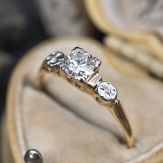 an engagement ring with three diamonds in it