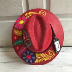 Stay stylish in this beautiful colorful hand painted straw hat, ideal for any sunny day occasion. Every single hat is hand painted uniquely which means there will never be another one like it. MADE IN MEXICO By: Mexican Artisans For: Women Size: Large (23.5") Color: red | multi Details: Material: Palm Straw Leather Band Inner elastic band Contact us for more details PLEASE READ BEFORE PURCHASE: The picture is an ACCURATE REPRESENTATION. Colors in the pictures may vary a little by effects of ligh Spring Festival Sun Hat Hand Painted, Hand Painted Adjustable Fedora, Multicolor Hand Painted Hat With Curved Brim, Spring Festival Hand Painted Sun Hat, Adjustable Hand Painted Sun Hat With Flat Brim, Adjustable Flat Brim Hand Painted Sun Hat, Multicolor Wide Brim Hand Painted Sun Hat, Adjustable Flat Brim Sun Hat Hand Painted, Bohemian Multicolor Hand Painted Straw Hat