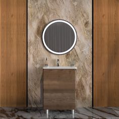 a bathroom vanity with a round mirror on the wall next to wooden paneled walls